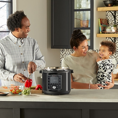 Familie kocht zusammen in der Küche mit einem Instant Pot. Glückliche Momente.